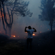 A man uses a cloth to protect himself from smoke in Rafina.